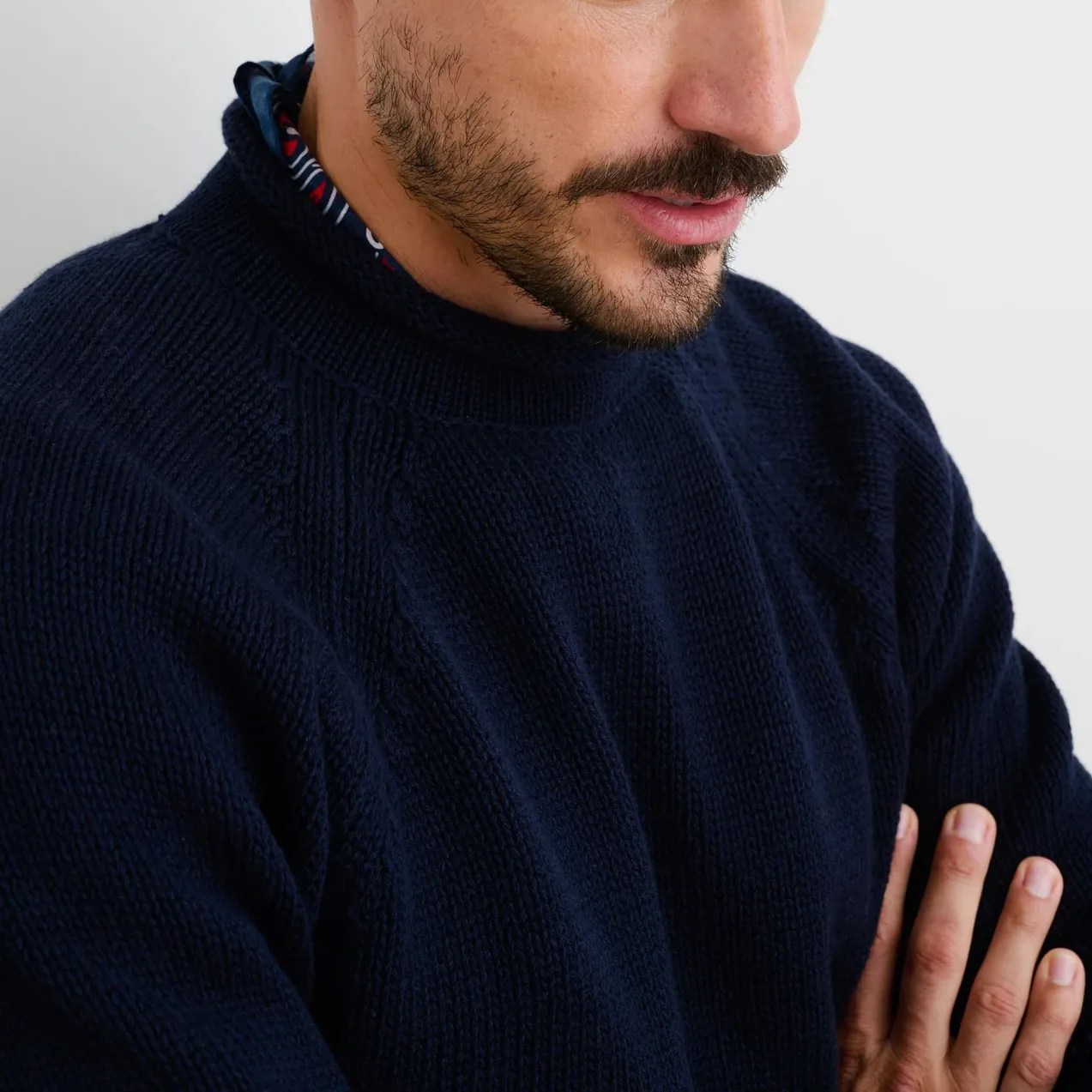 man wearing blue roll neck sweater