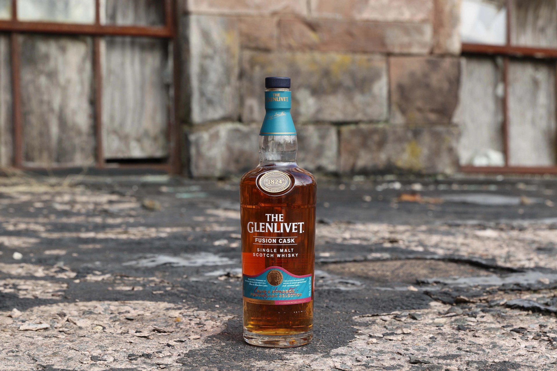 bottle of scotch whisky outside an old building