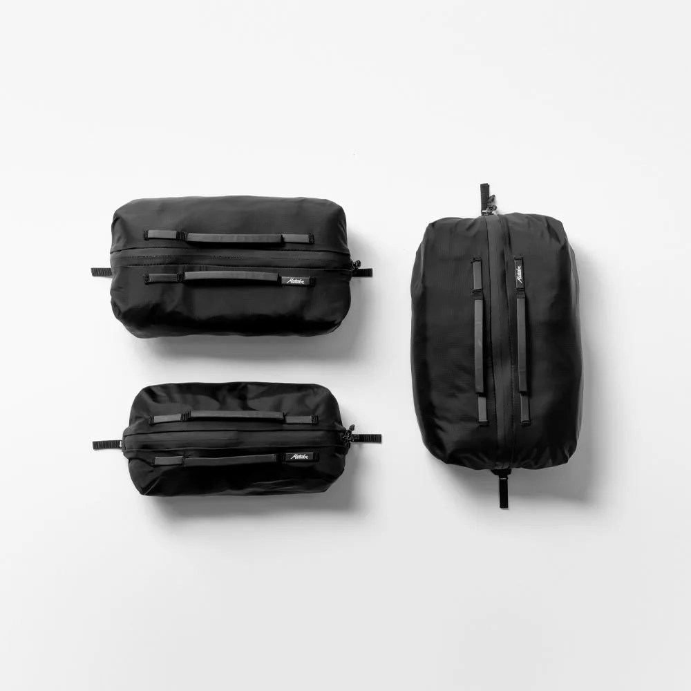 Three black matador gear packing cubes arranged side by side on a white background