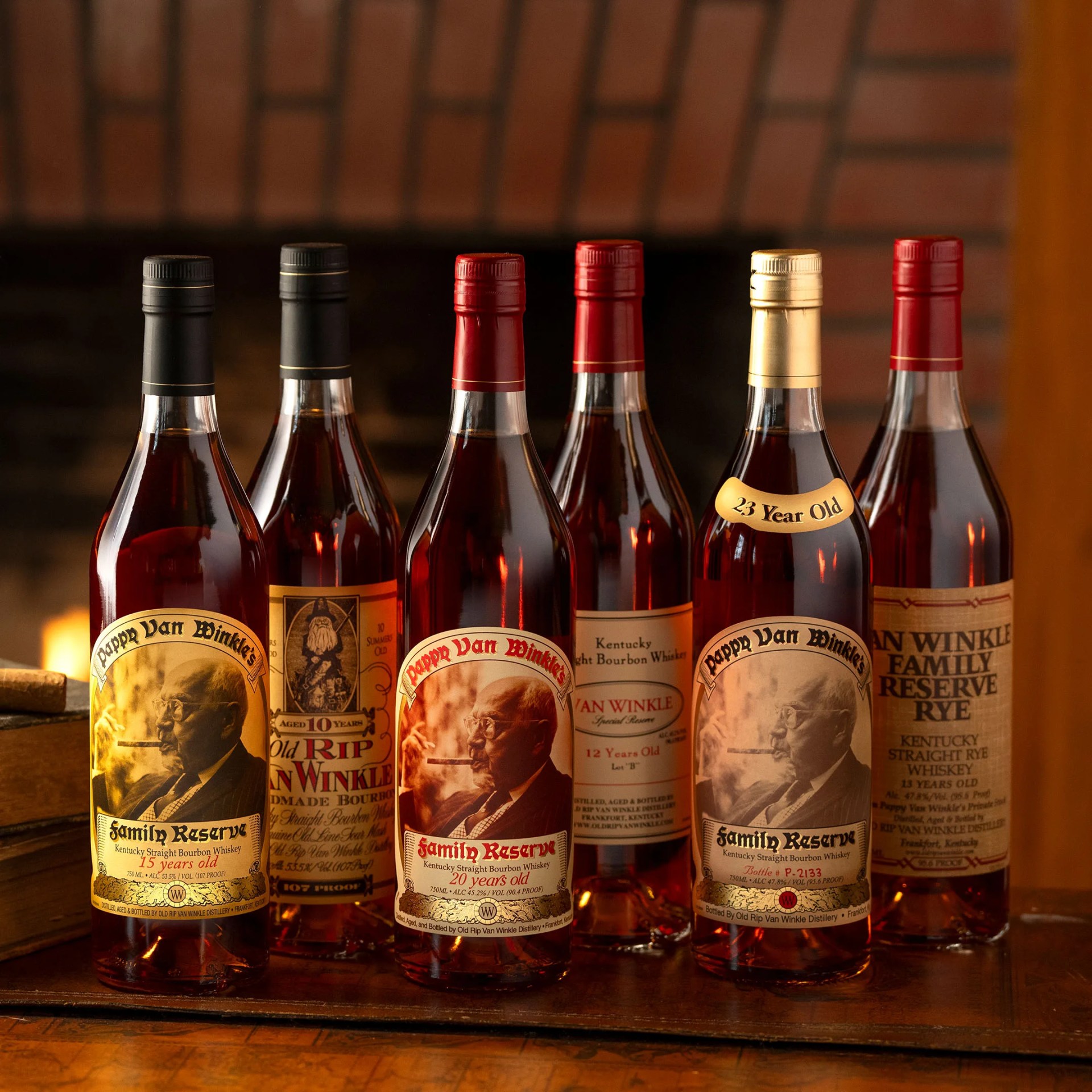 six bottles of van winkle whiskey in front of a fireplace