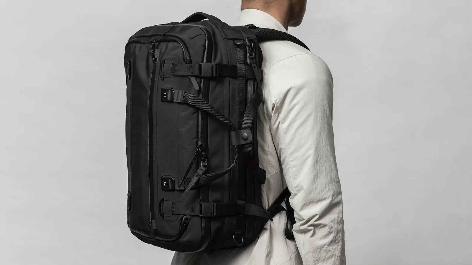 Black Ember Forge 40 Backpack shown being worn on a man's back from an angle