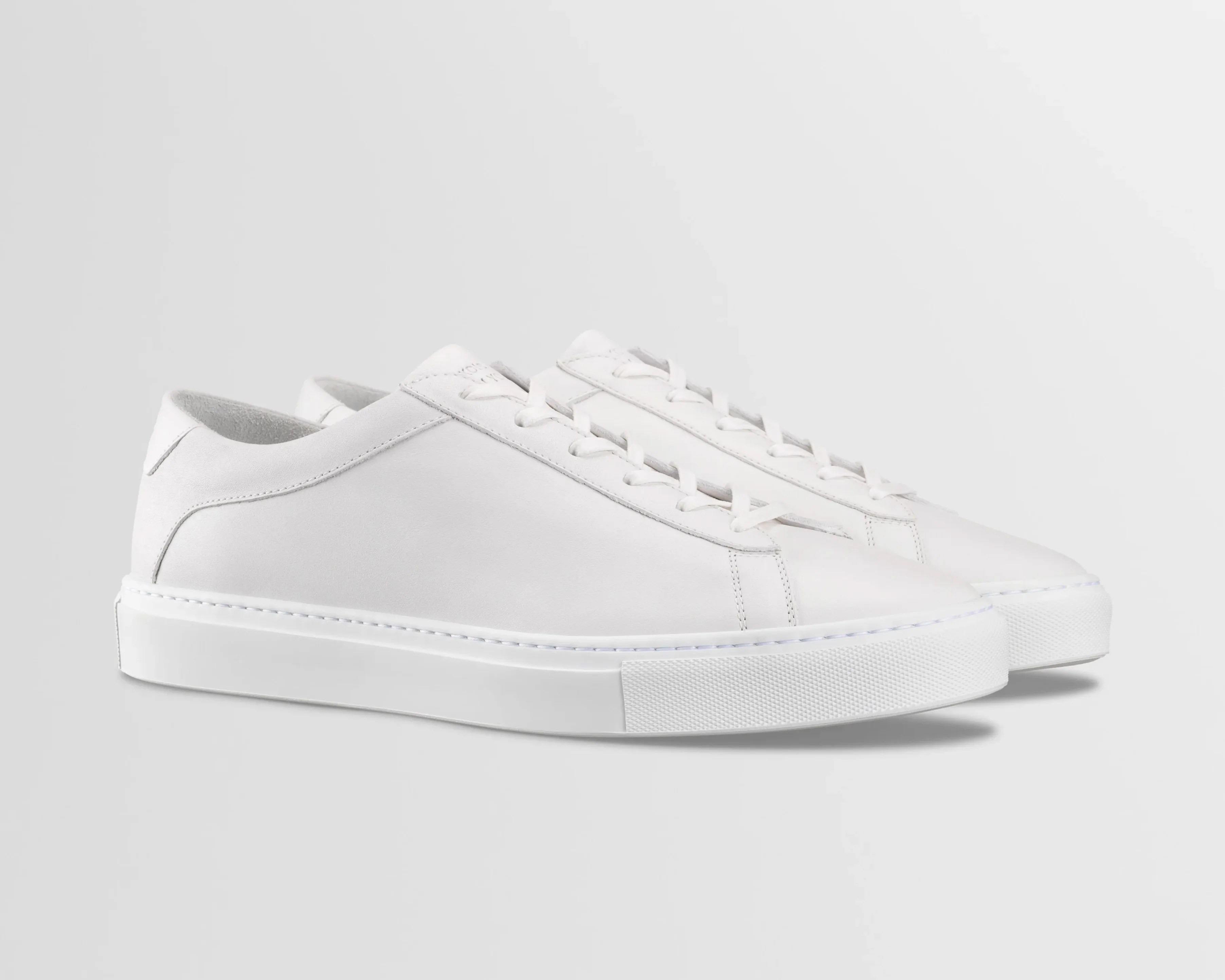 A pair of white leather sneakers