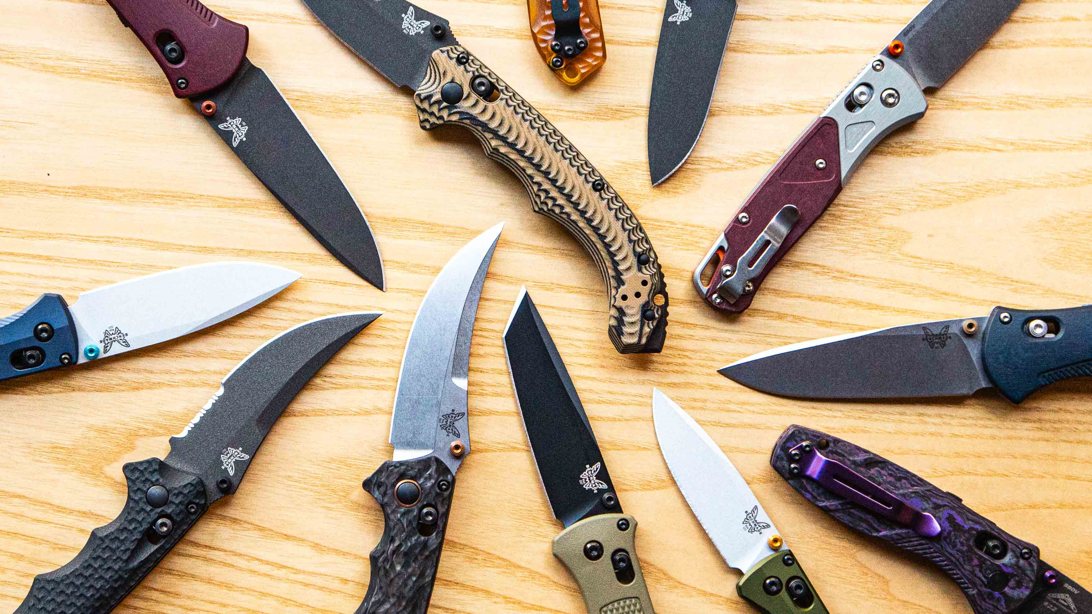 pocket knives on a wooden table