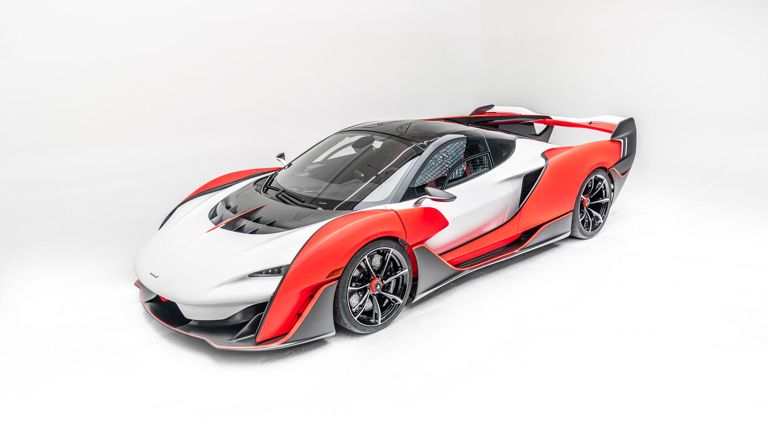 A view of a red and white McLaren Sabre, in studio lighting