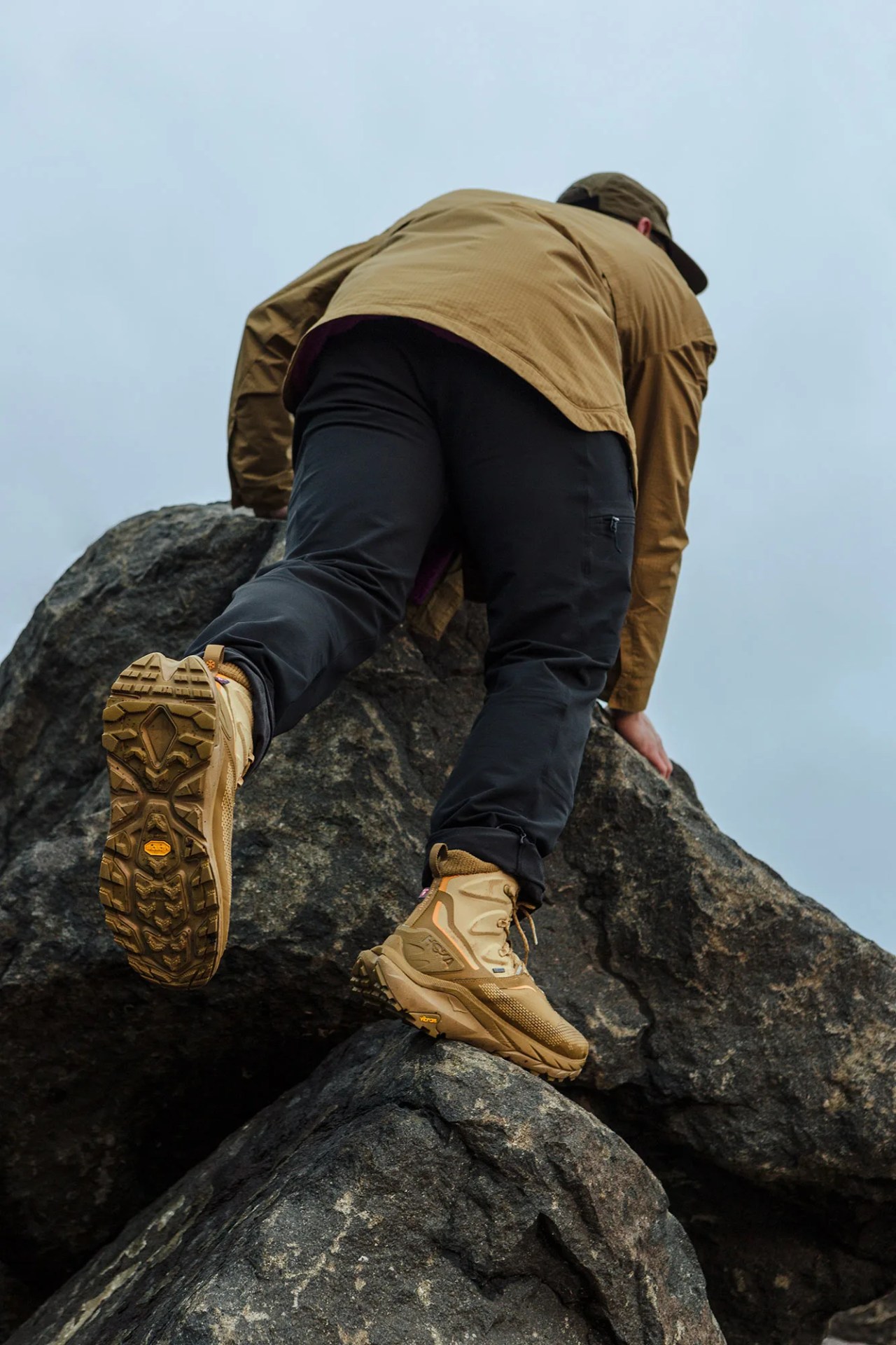 A man hikes in HOKA Kaha 2 Frost GTX shoes