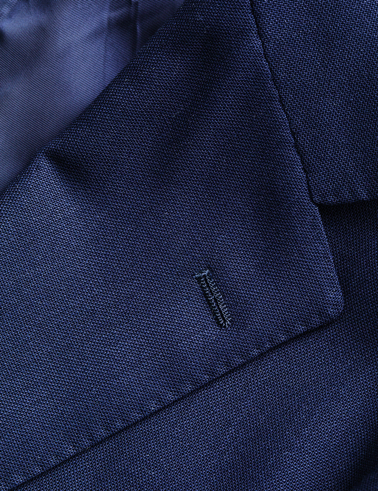 Why Do Suits Have A Random Buttonhole On The Lapel? We Found Out