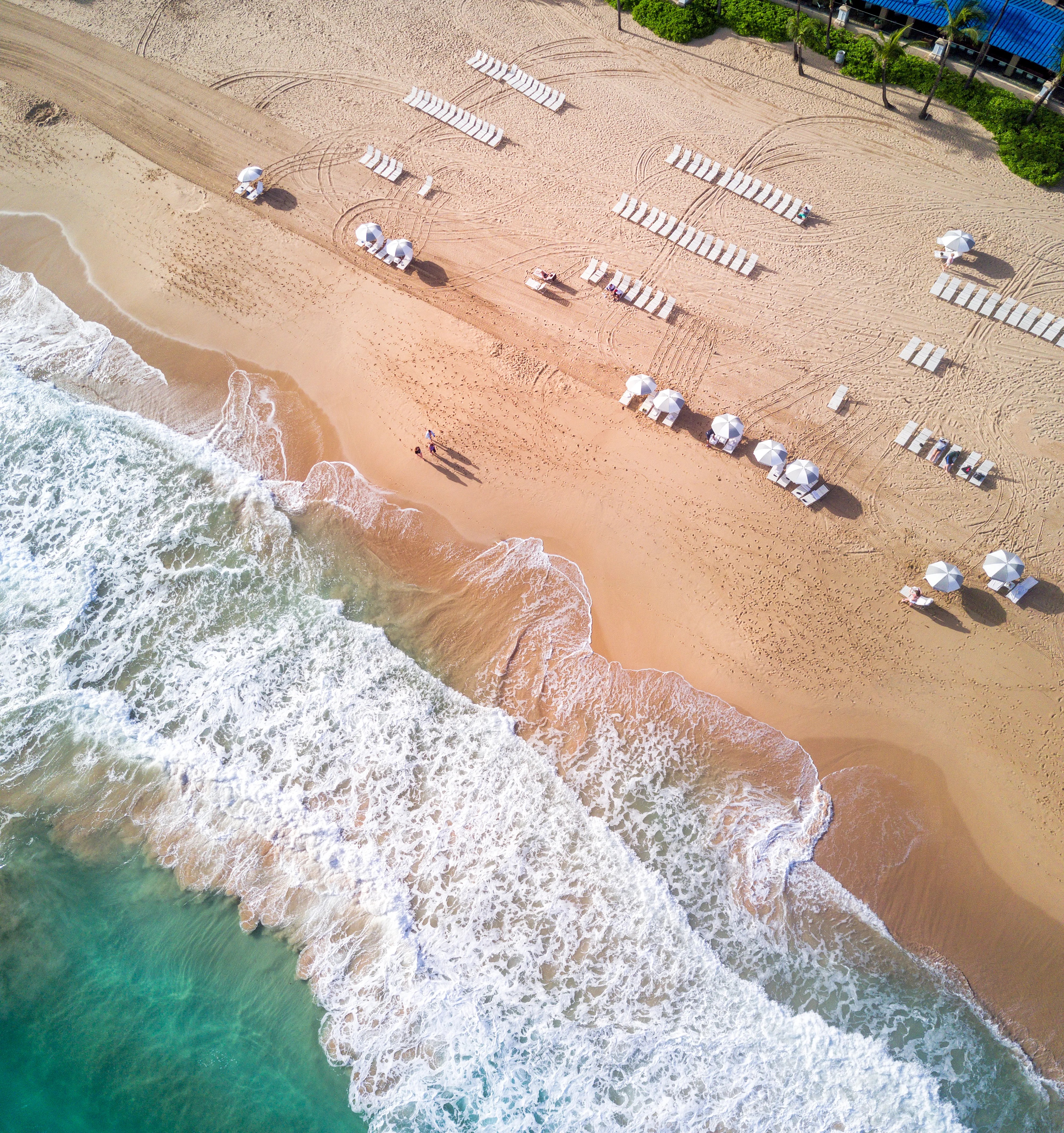 Birdseye view of waves crashing onto a beach in coronado san juan puerto rico