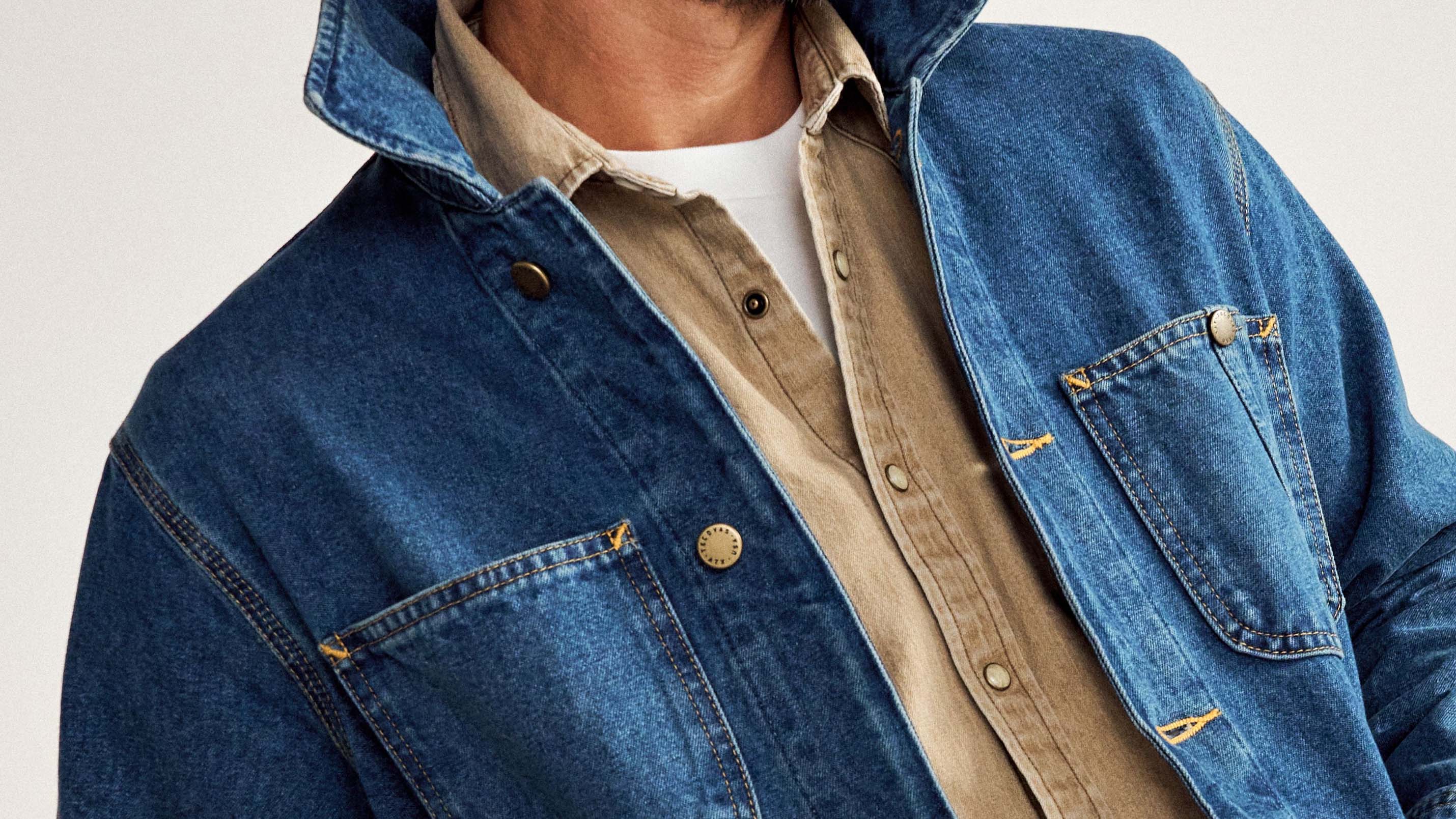 close up of a blue Tecovas denim chore coat